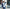 man standing in front of windows with mannequins