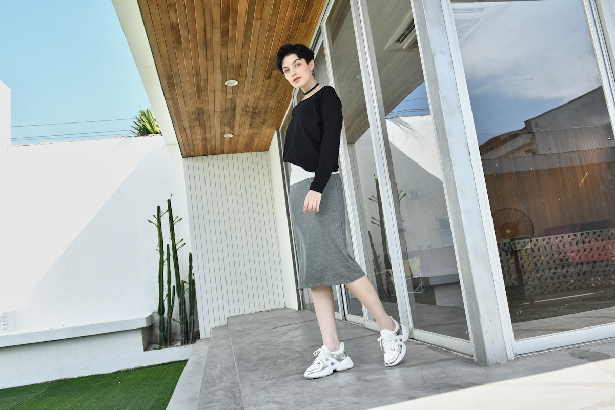 a woman is standing outside of a house