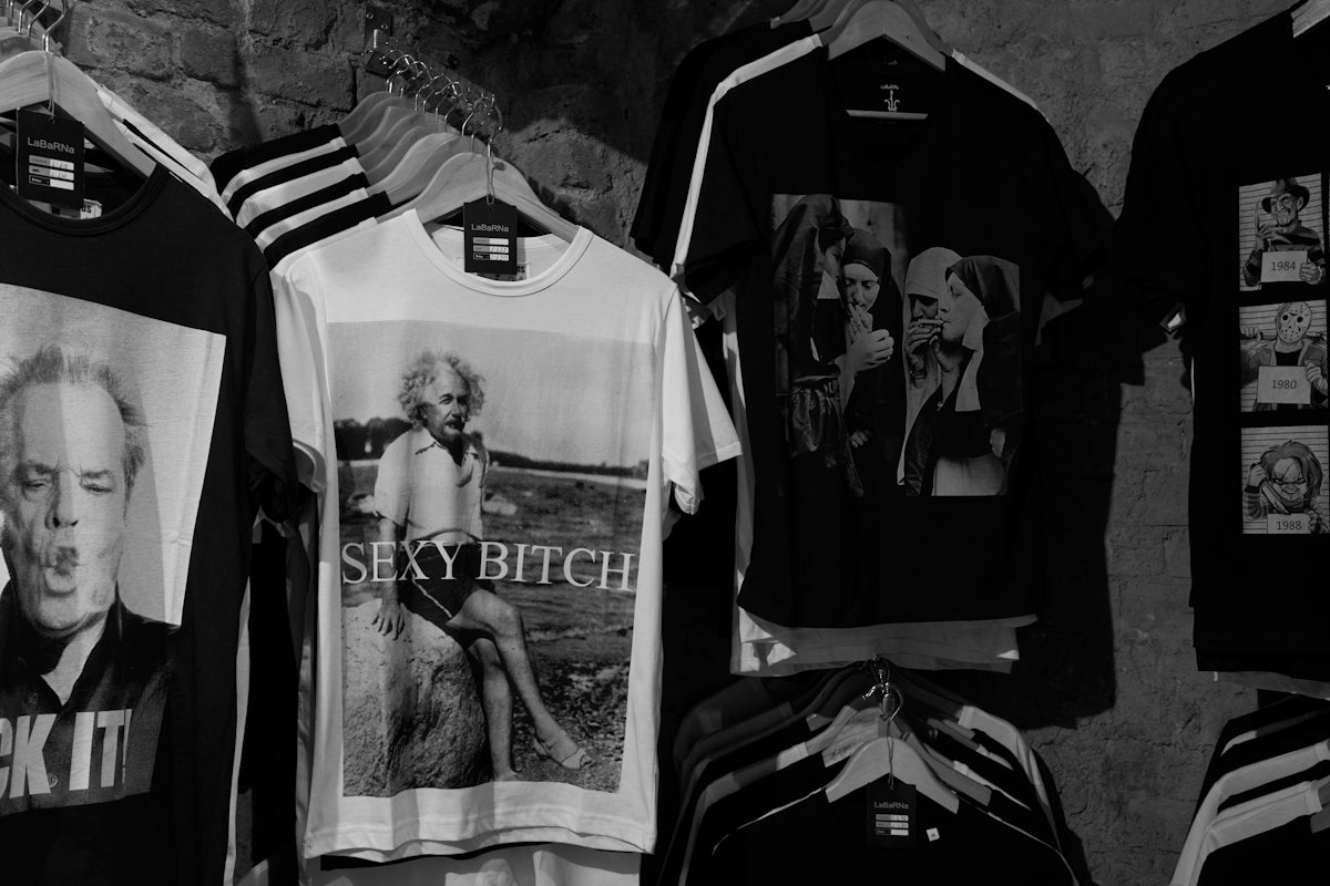a bunch of shirts that are hanging on a wall