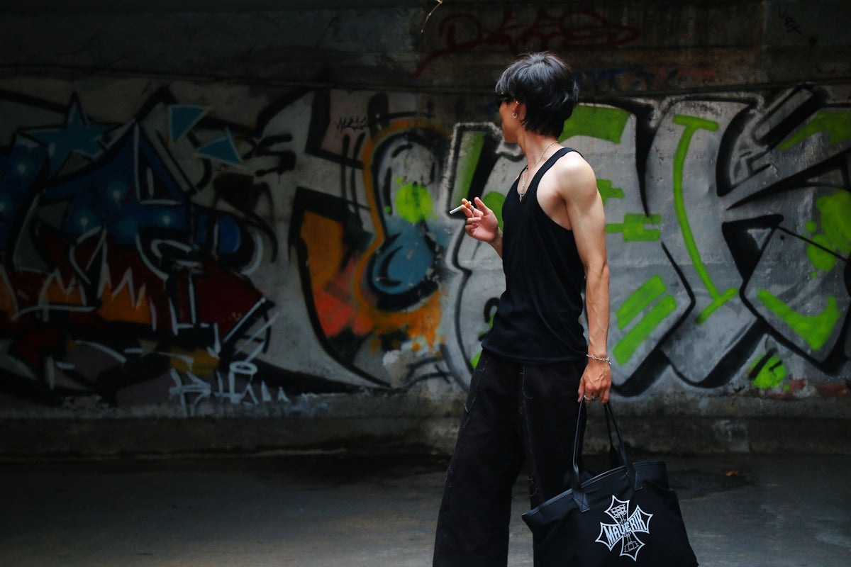a man walking with a bag and a cell phone