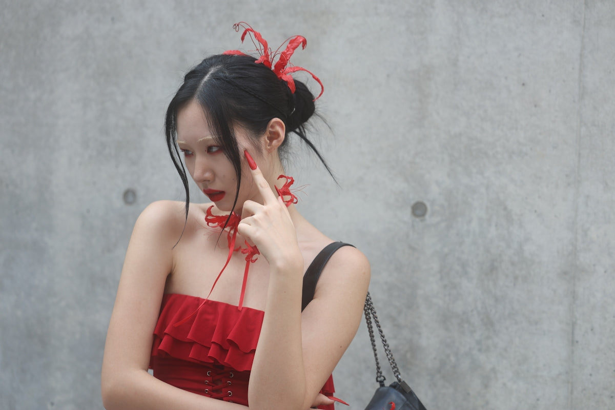 A woman in a red dress talking on a cell phone