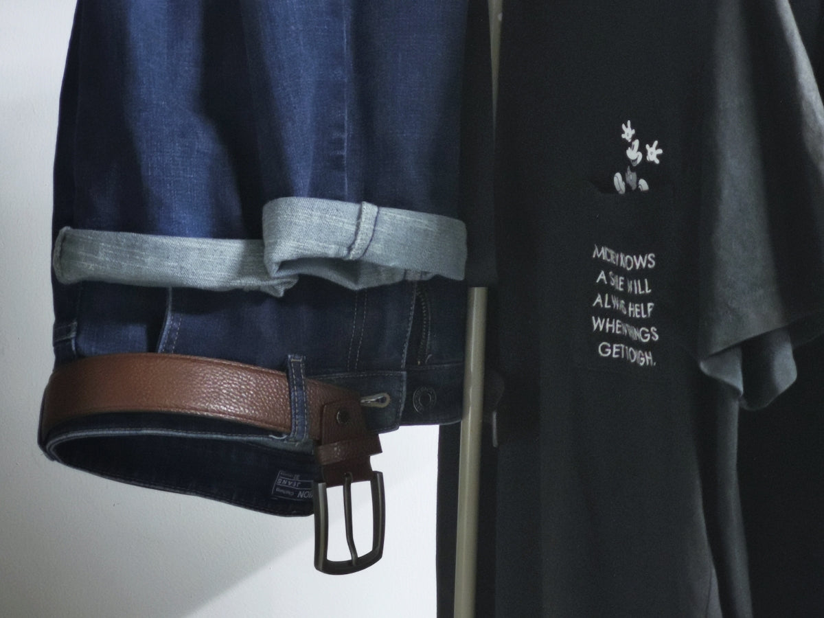 a pair of jeans hanging on a clothes rack
