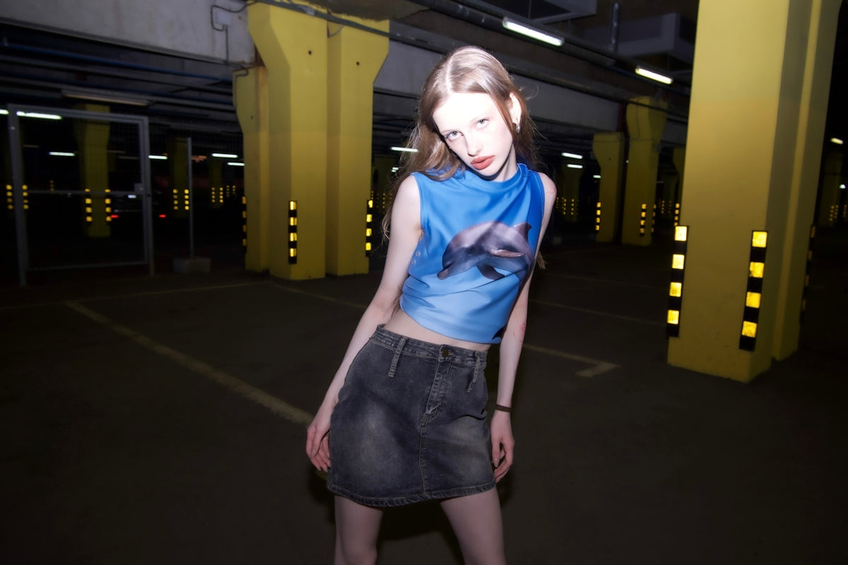 a woman in a blue shirt and a black skirt