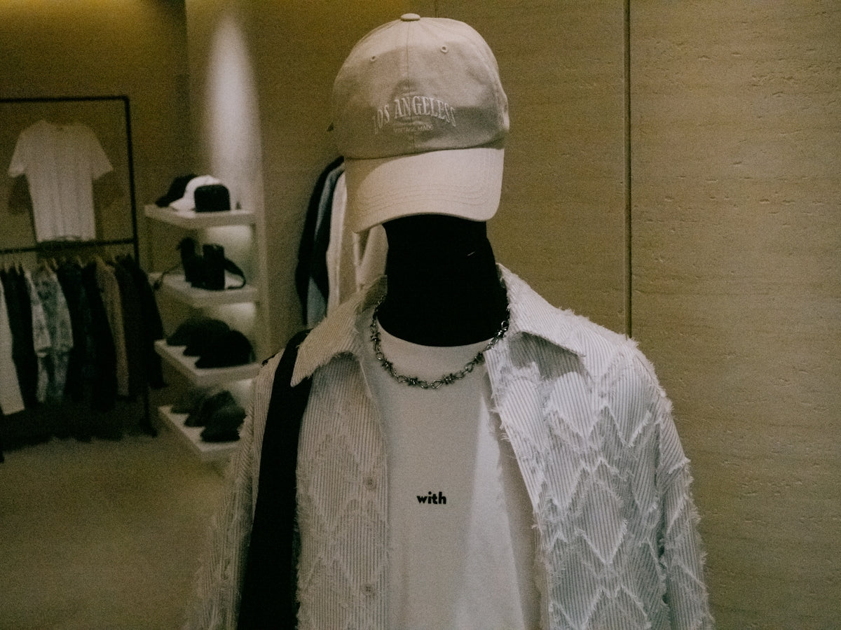A mannequin wearing a white hat and a white shirt