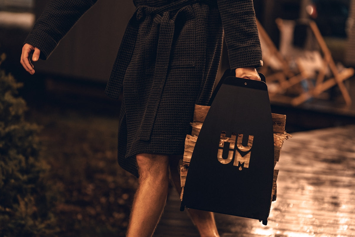 A woman walking down a street holding a suitcase